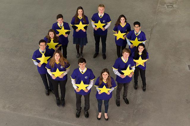 Generation euro -kuvituskuva, jossa nuoria piirissä keltaiset tähdet kädessään